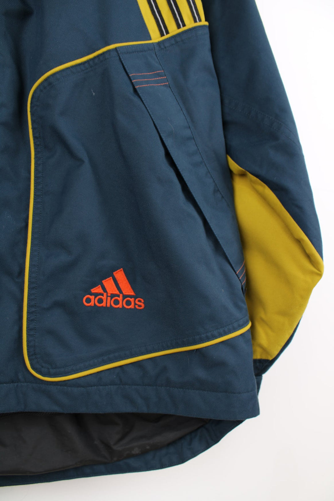 Vintage Adidas coat in blue and yellow. Features embroidered logo.