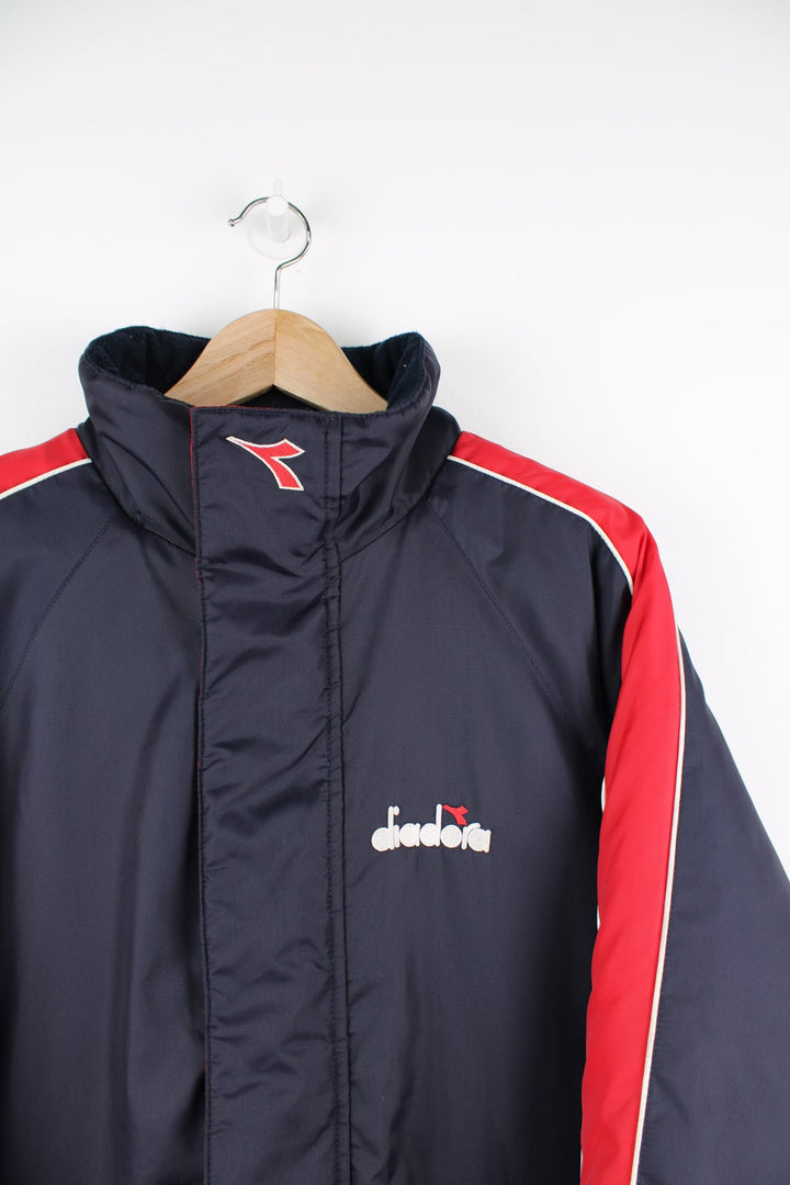 Vintage blue and red Diadora coat featuring embroidered logo on the front and back.