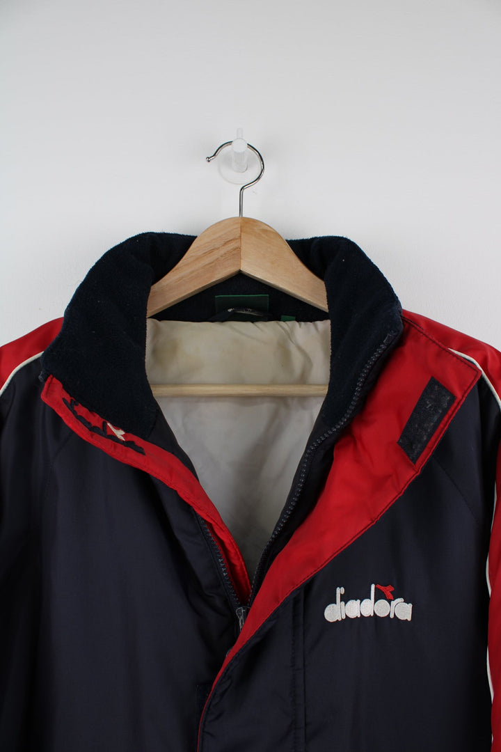 Vintage blue and red Diadora coat featuring embroidered logo on the front and back.