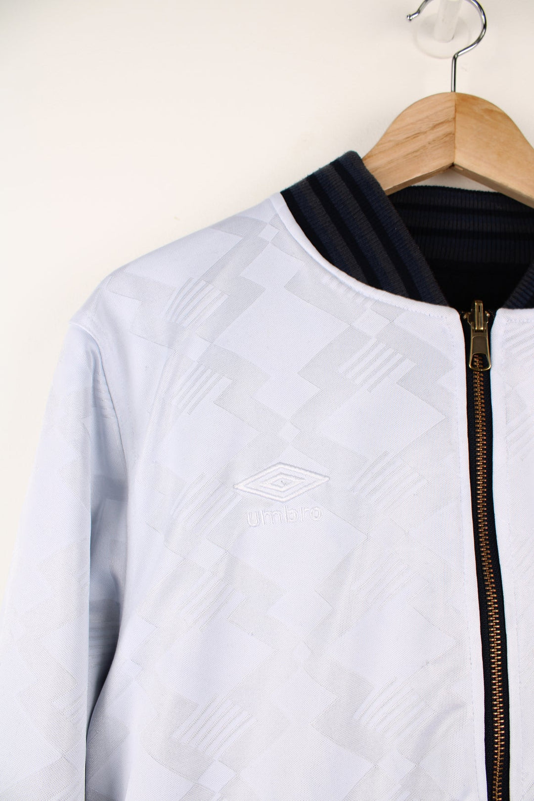 Vintage Umbro reversible white and blue bomber jacket. Features embroidered logo on the chest.