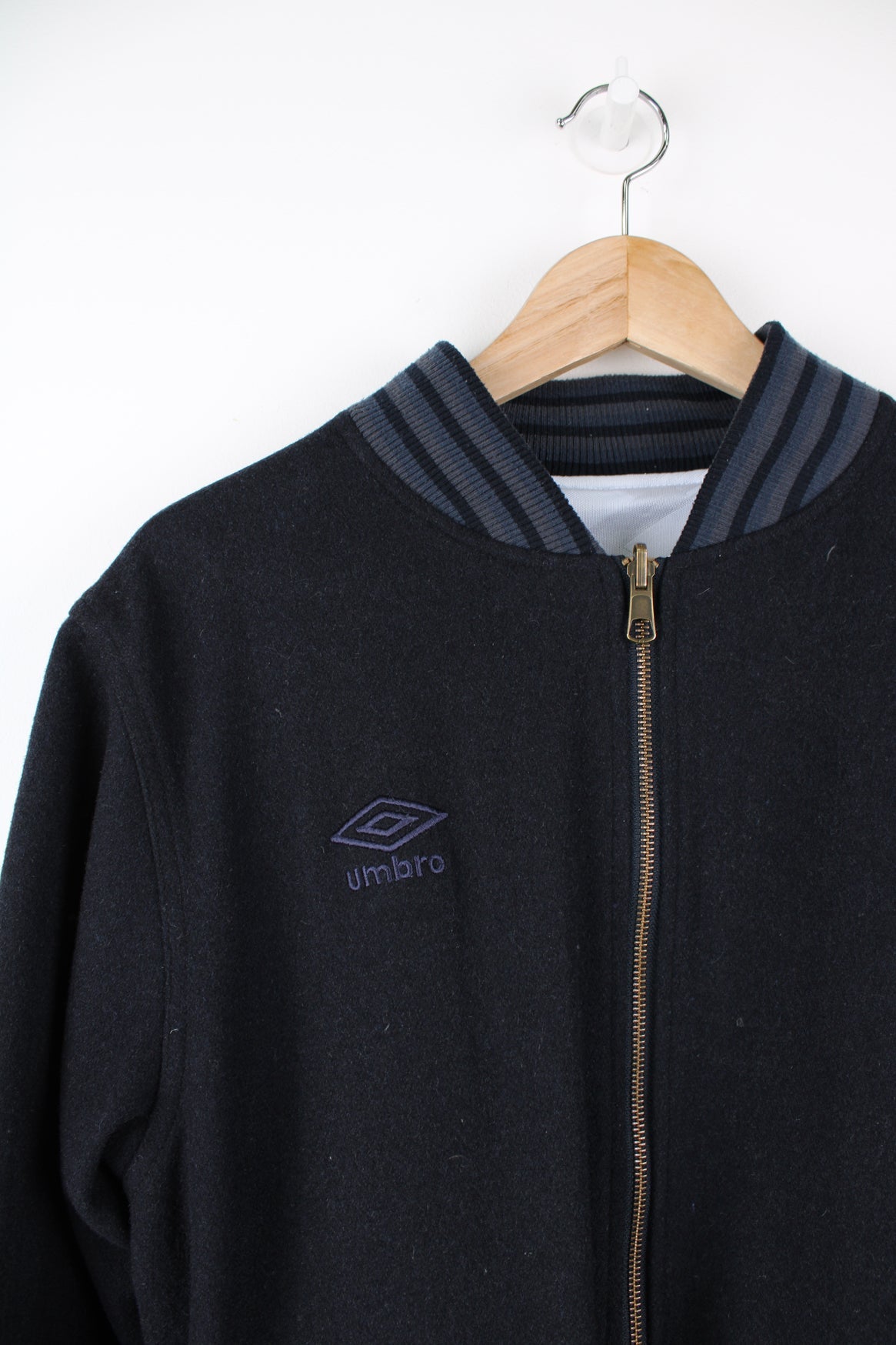 Vintage Umbro reversible white and blue bomber jacket. Features embroidered logo on the chest.