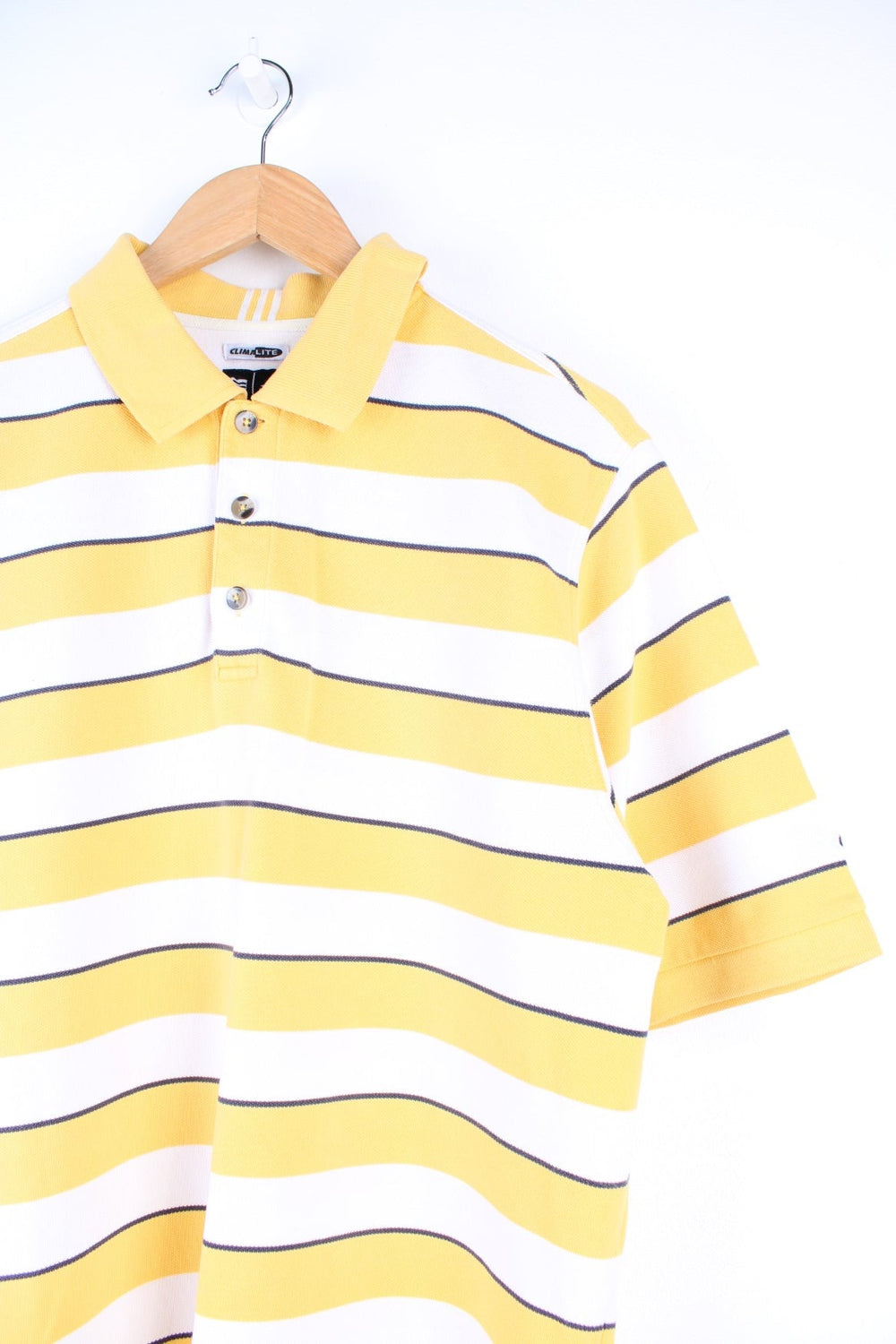 Adidas Climalite Polo Shirt in a yellow, black and white striped colourway, button up, and has logo embroidered on the left sleeve. 