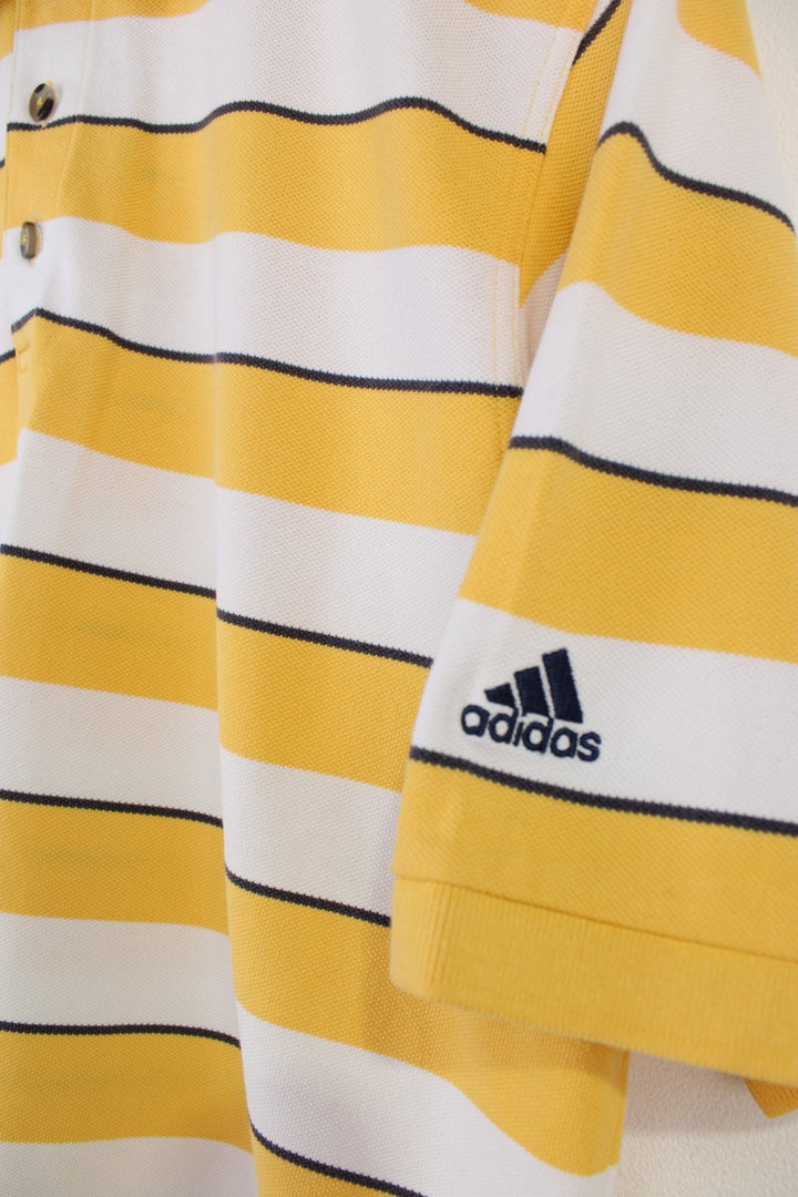 Adidas Climalite Polo Shirt in a yellow, black and white striped colourway, button up, and has logo embroidered on the left sleeve. 