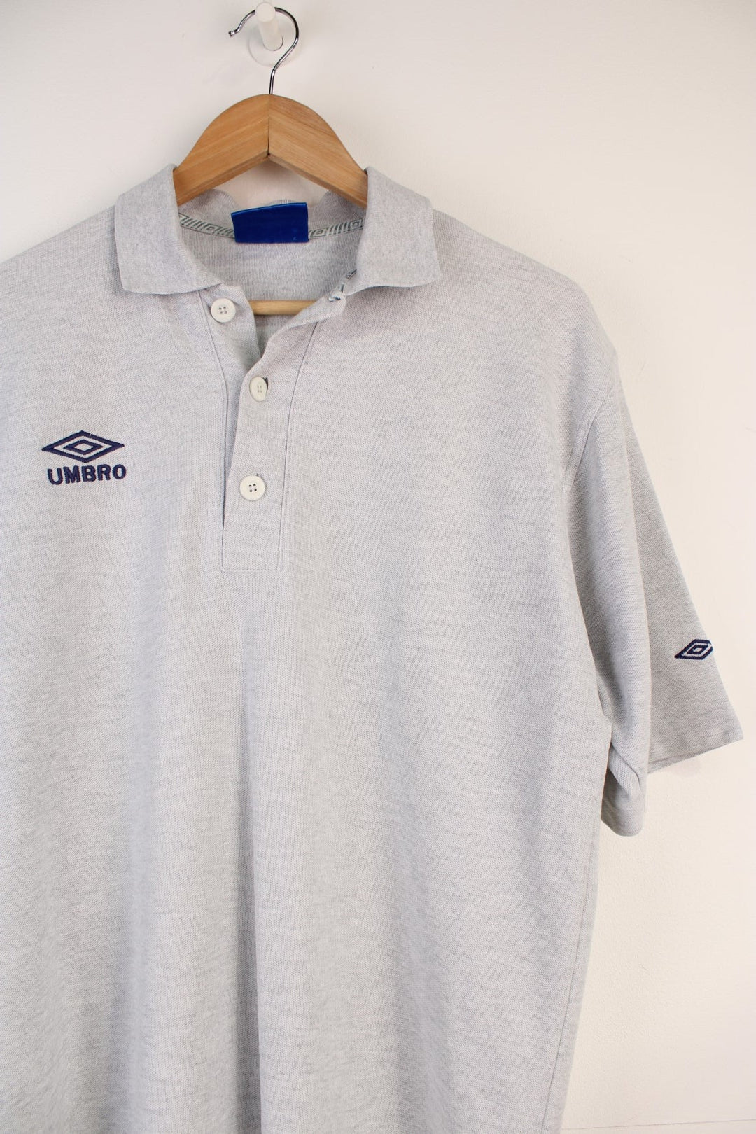 Umbro Polo Shirt in a grey colourway, button up and has the logo embroidered on the front. 