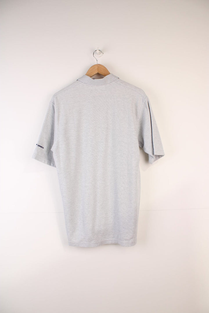 Umbro Polo Shirt in a grey colourway, button up and has the logo embroidered on the front. 