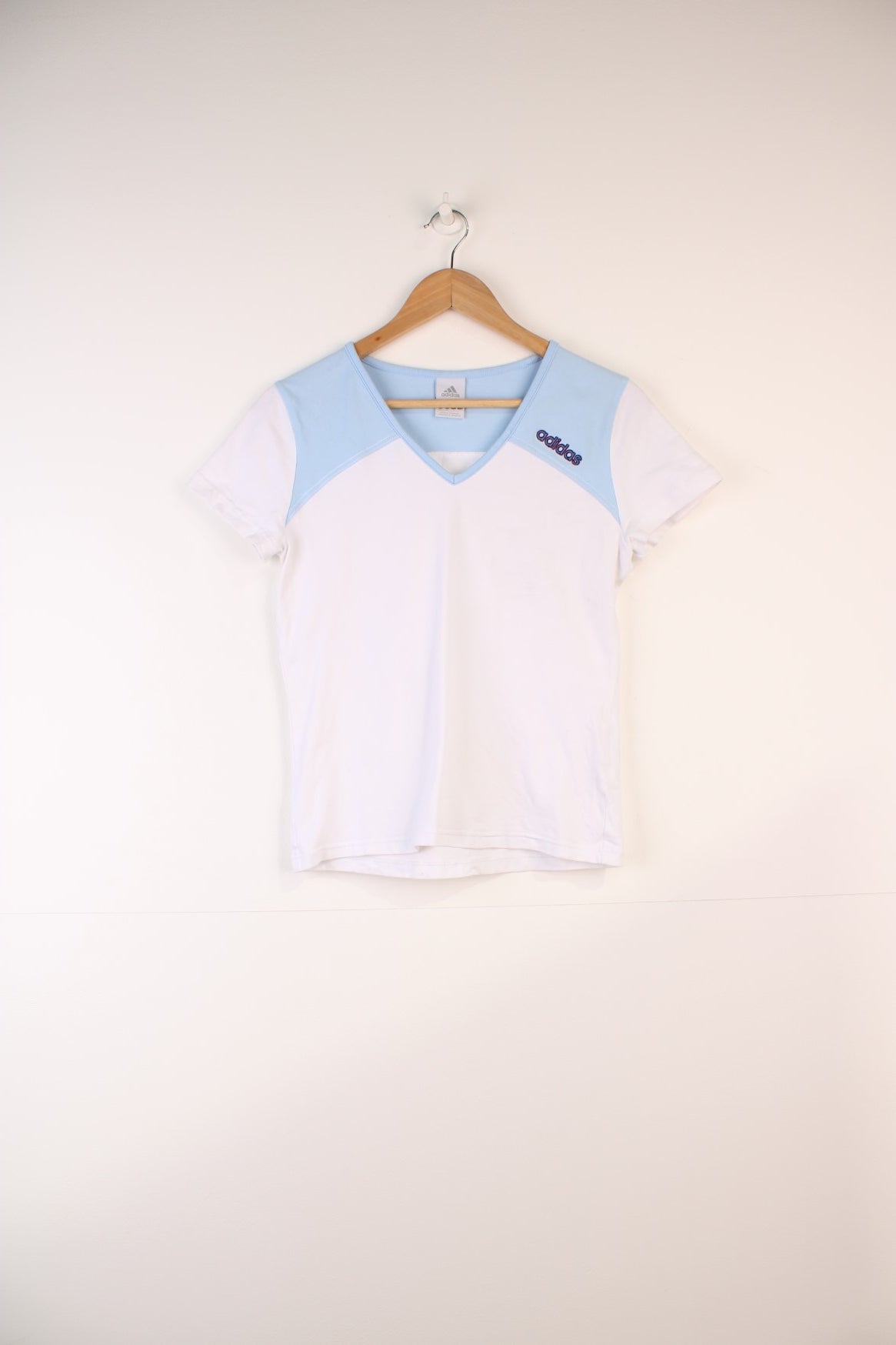 Adidas Top in a white and blue colourway, v neck, and has the logo embroidered on the front and back.