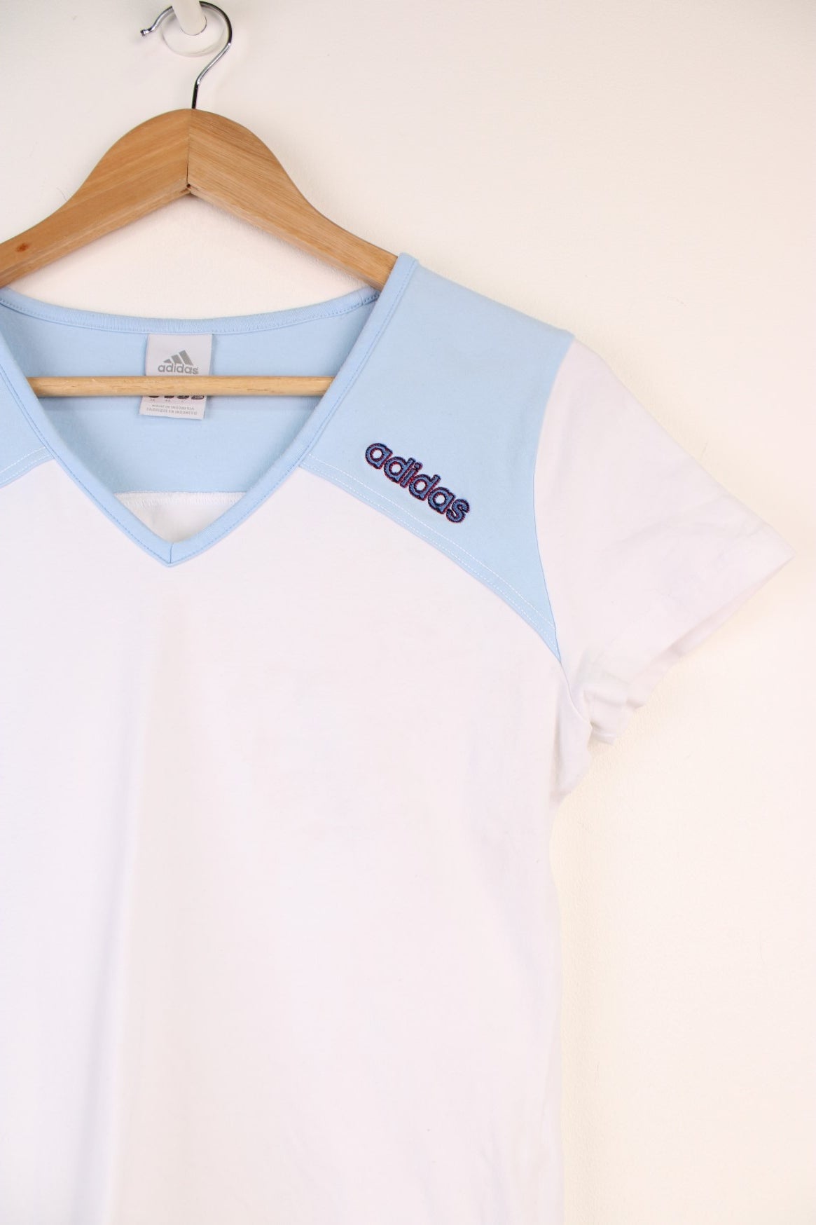 Adidas Top in a white and blue colourway, v neck, and has the logo embroidered on the front and back.