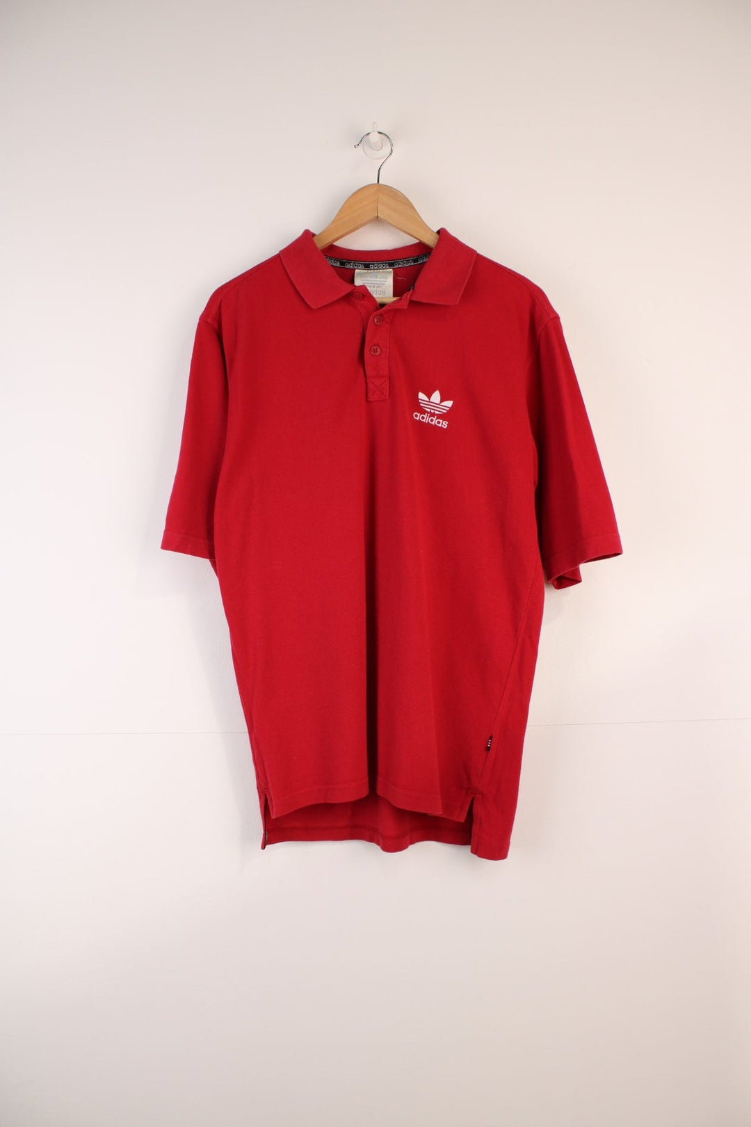 Adidas Polo Shirt in a red colourway, button up and has the logo embroidered on the front. 