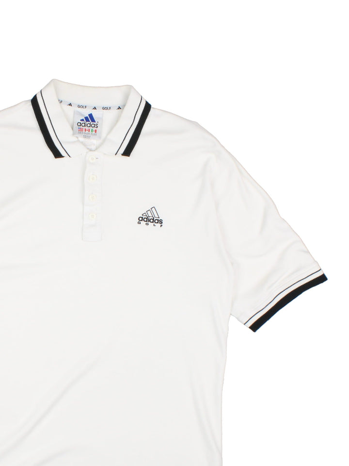 Adidas Golf Polo Shirt in a white and black colourway with a button up collar and the logo embroidered on the front and back.