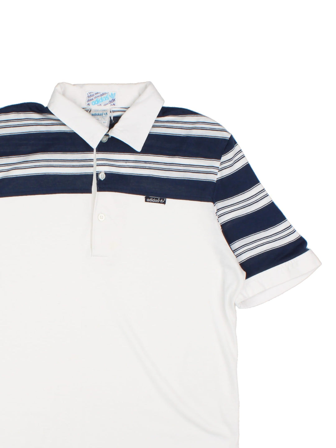 Vintage Adidas Polo Shirt in a white and blue striped colourway with a button up collar and the logo embroidered on the front.