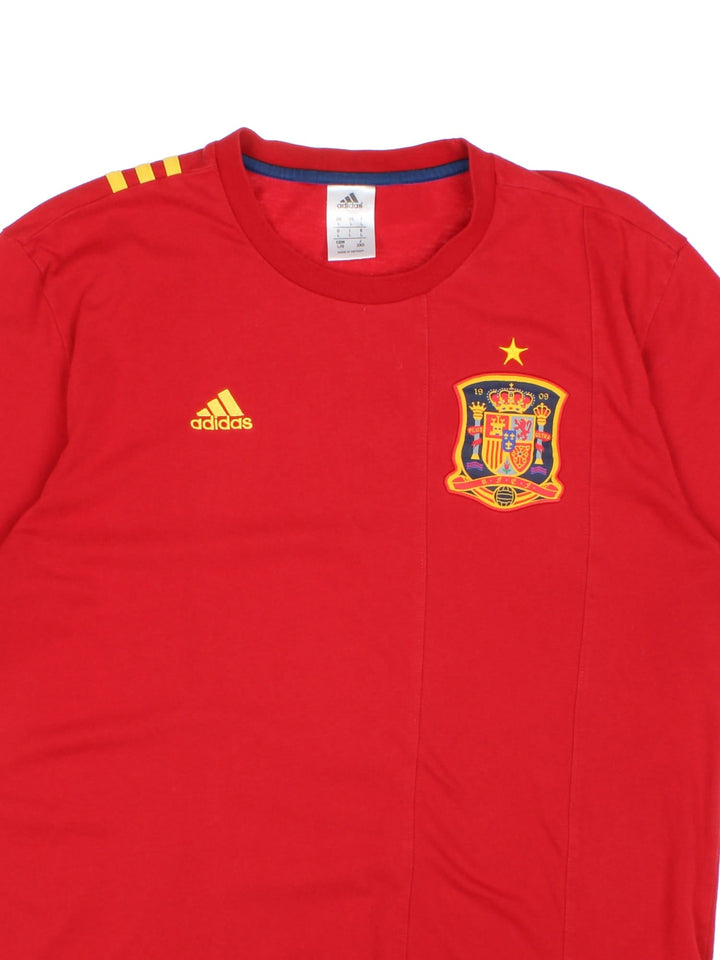 Adidas Spain Football T-Shirt in a red colourway with the logos embroidered on the front and on the back the three iconic stripes.