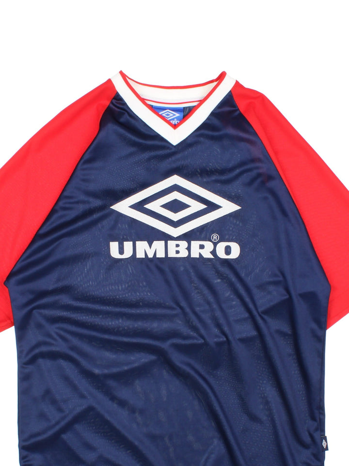 Vintage 90's Umbro Training Top in a blue and red colourway, v neck collar, has the logo and spell out embroidered on the front and on the back number 9 printed.