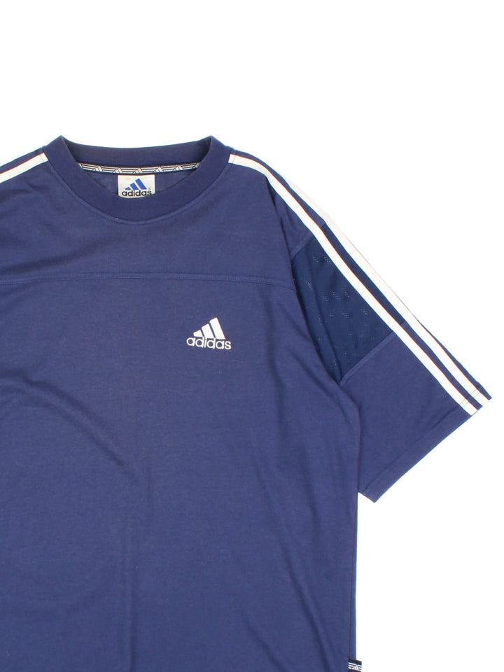 Vintage Adidas T-Shirt in a blue colourway, cotton t-shirt with part polyester mesh material on the sleeves, and has the logo embroidered on the front.