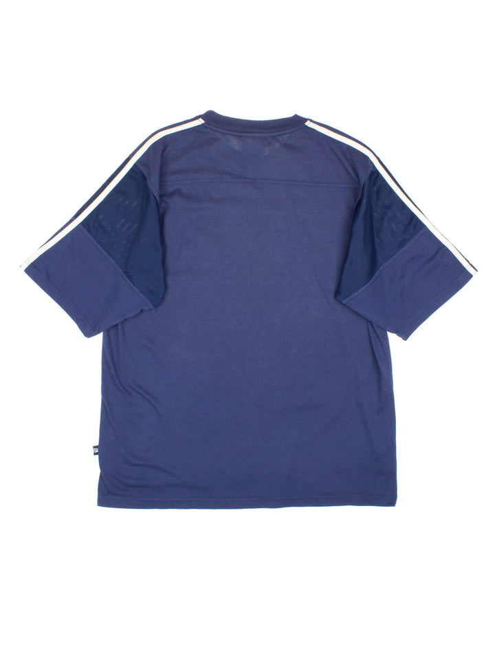 Vintage Adidas T-Shirt in a blue colourway, cotton t-shirt with part polyester mesh material on the sleeves, and has the logo embroidered on the front.