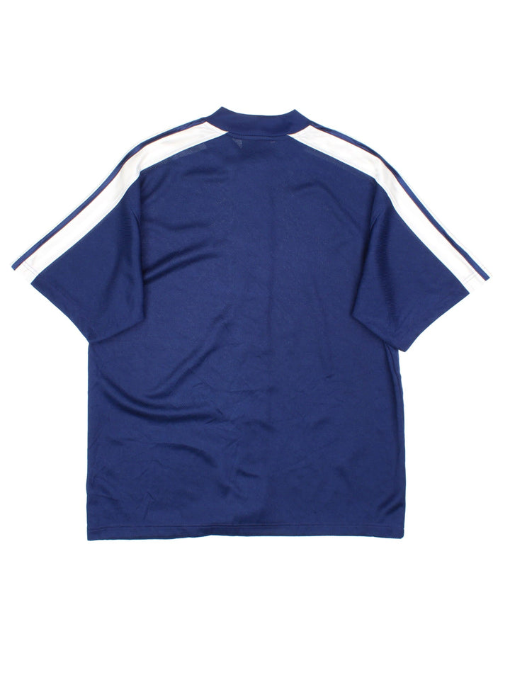 Vintage Adidas Snap Shooting Basketball Shirt in a blue and white colourway, snap button up, and has the logo badge embroidered on the front.