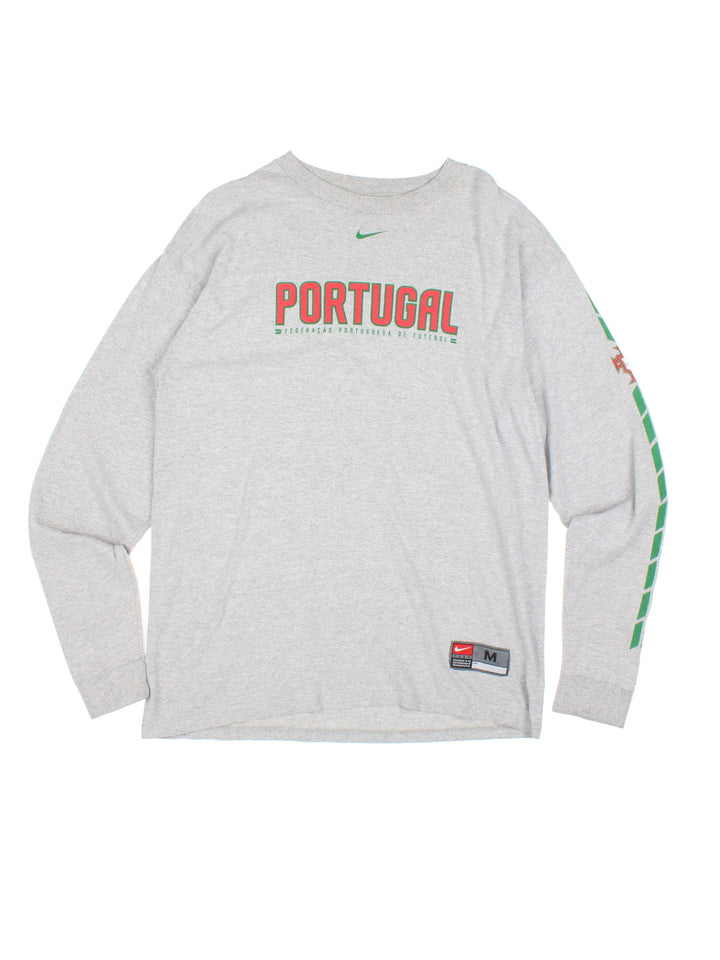 Y2K Nike Portugal Football Longsleeve T-Shirt in a grey colourway with the spell out and logo printed on the front and down the left sleeve.