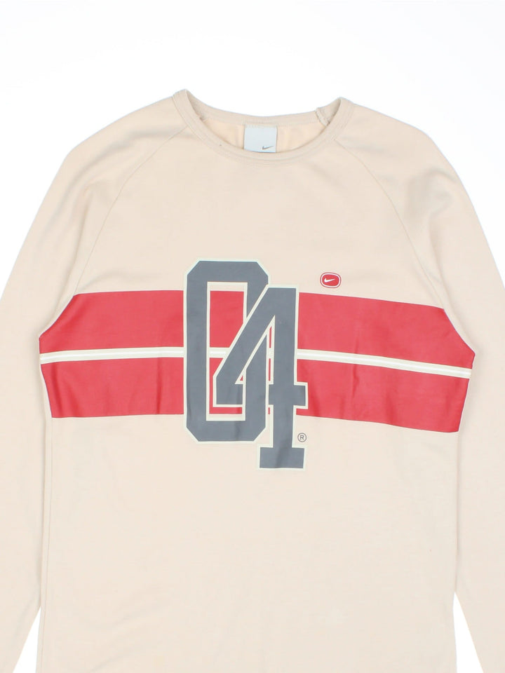 Y2K Nike Cortez Longsleeve T-Shirt in a tan colourway with the logo and graphic printed on the front.