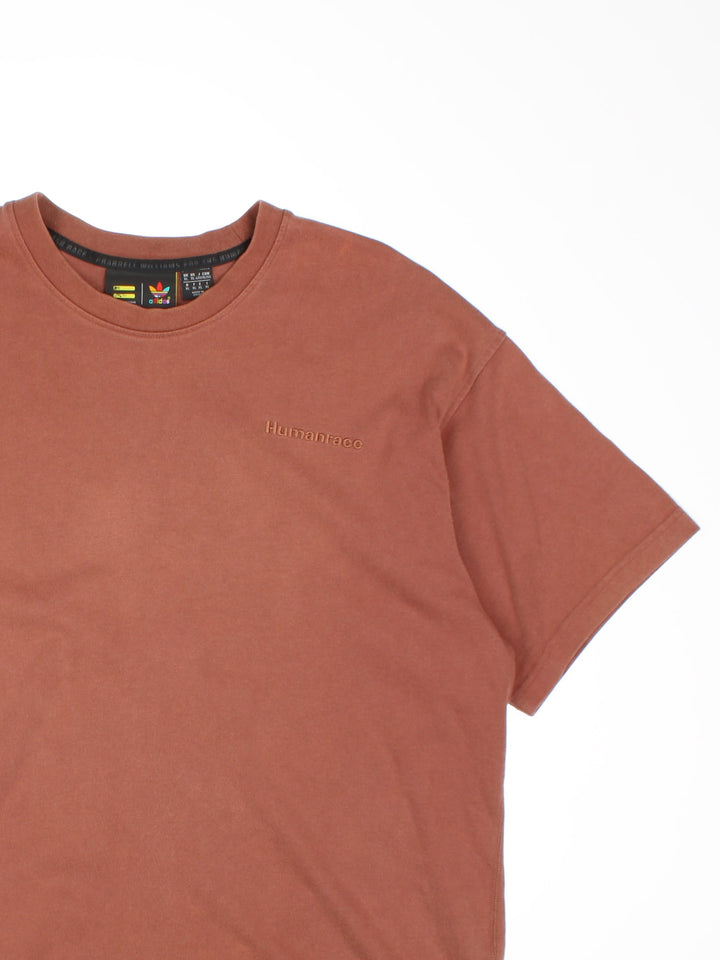 Adidas Humanrace by Pharrell Williams Basics T-Shirt in a brown colourway with the spell out logo embroidered on the front.