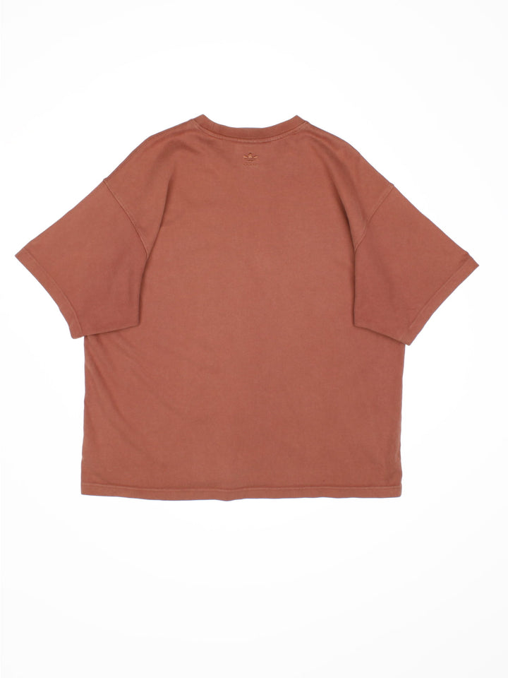 Adidas Humanrace by Pharrell Williams Basics T-Shirt in a brown colourway with the spell out logo embroidered on the front.