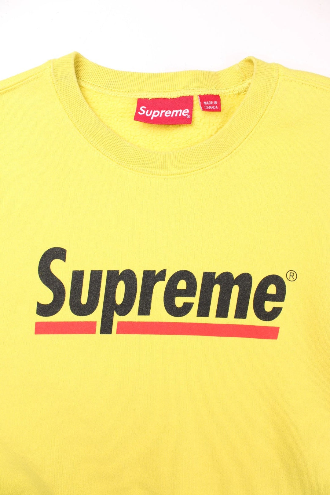 Supreme Underline sweatshirt in yellow with a printed spellout in black and red on the front.