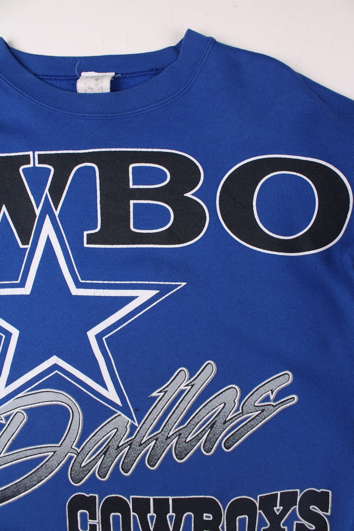 Dallas Cowboys NFL sweatshirt in blue with a large printed graphic spanning the front and sleeves.