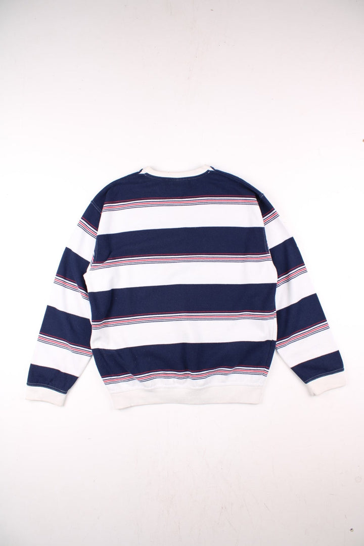 Reebok raglan sleeve sweatshirt in blue, white, and red stripes with a small embroidered logo on the chest.