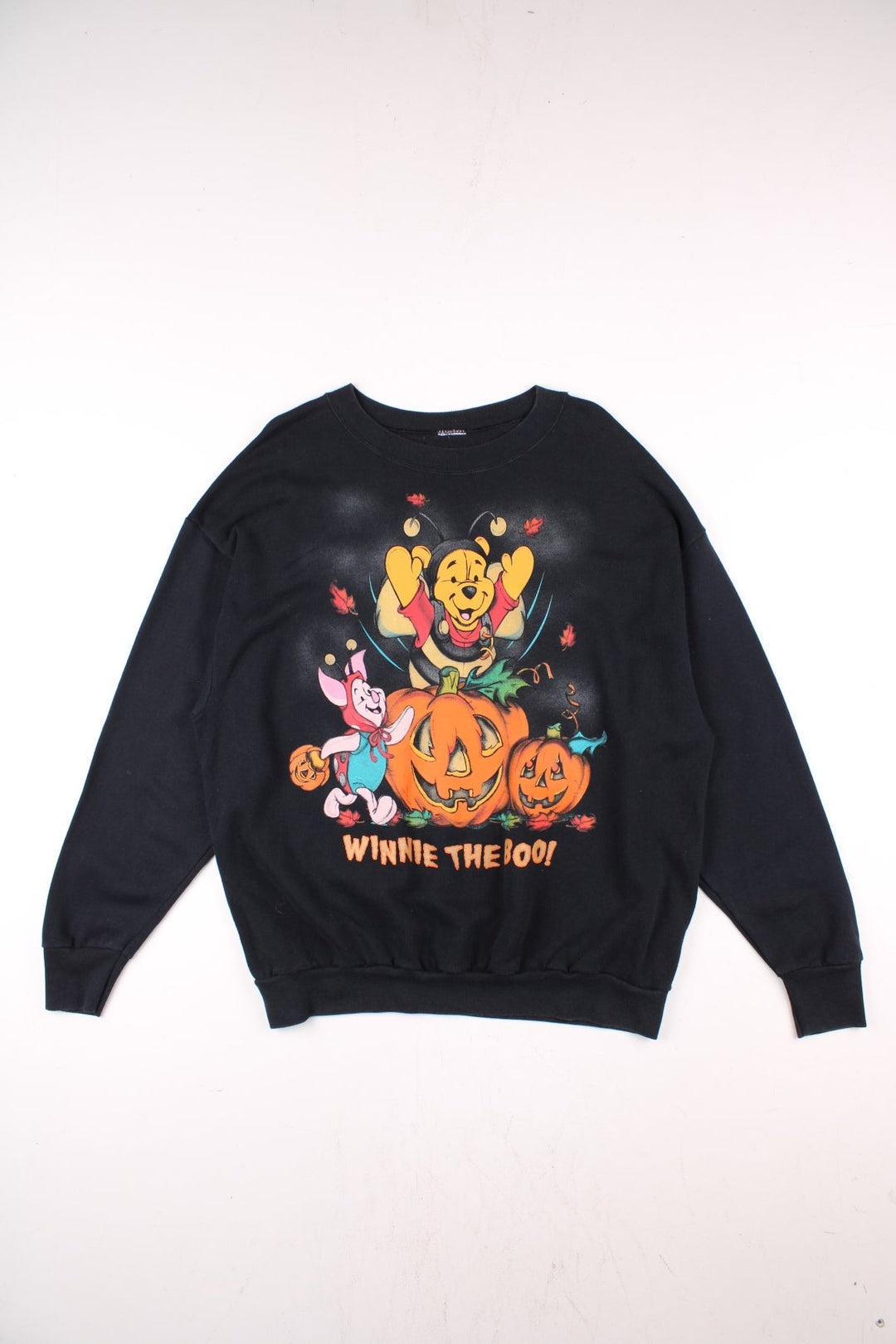 Disney Winnie the Pooh Halloween themed sweatshirt in black with large graphic of Winnie and Piglet in costrume with pumpkins and text reading 'Winnie the Boo!'.