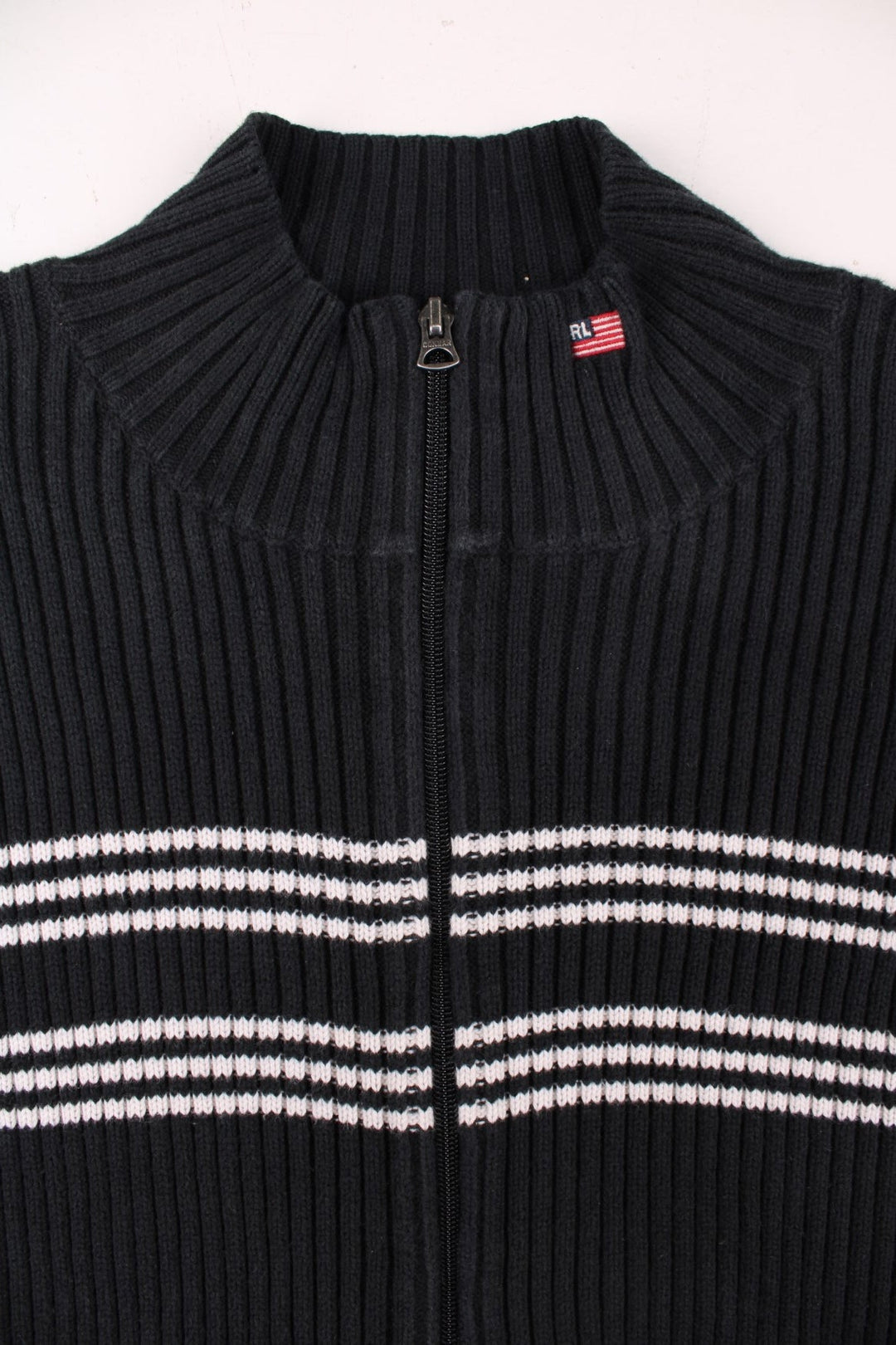 Ralph Lauren zip-through cardigan in black with white stripe detailing and a small embroidered 'RL' U.S. flag logo embroidered at the collar.