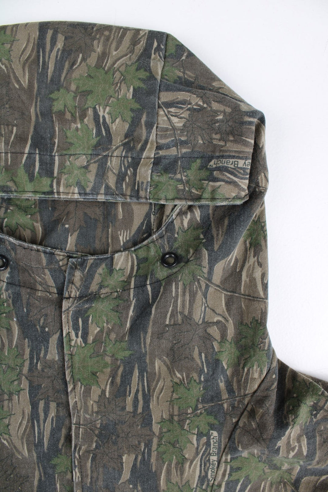 Vintage Smokey Branch Camo Pullover Hoodie in a green colourway with camo print. Front zip pocket and drawstring.