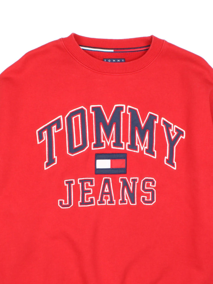 Tommy Hilfiger Tommy Jeans sweatshirt in a red colourway with a large logo embroidered on the front and a small patch stitched on the hem.