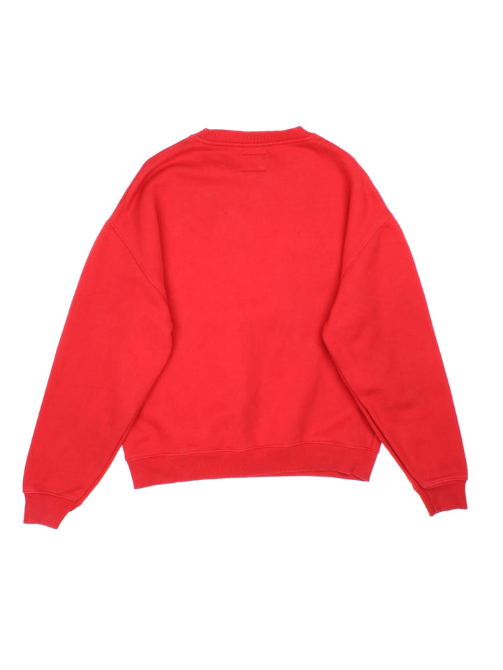 Tommy Hilfiger Tommy Jeans sweatshirt in a red colourway with a large logo embroidered on the front and a small patch stitched on the hem.