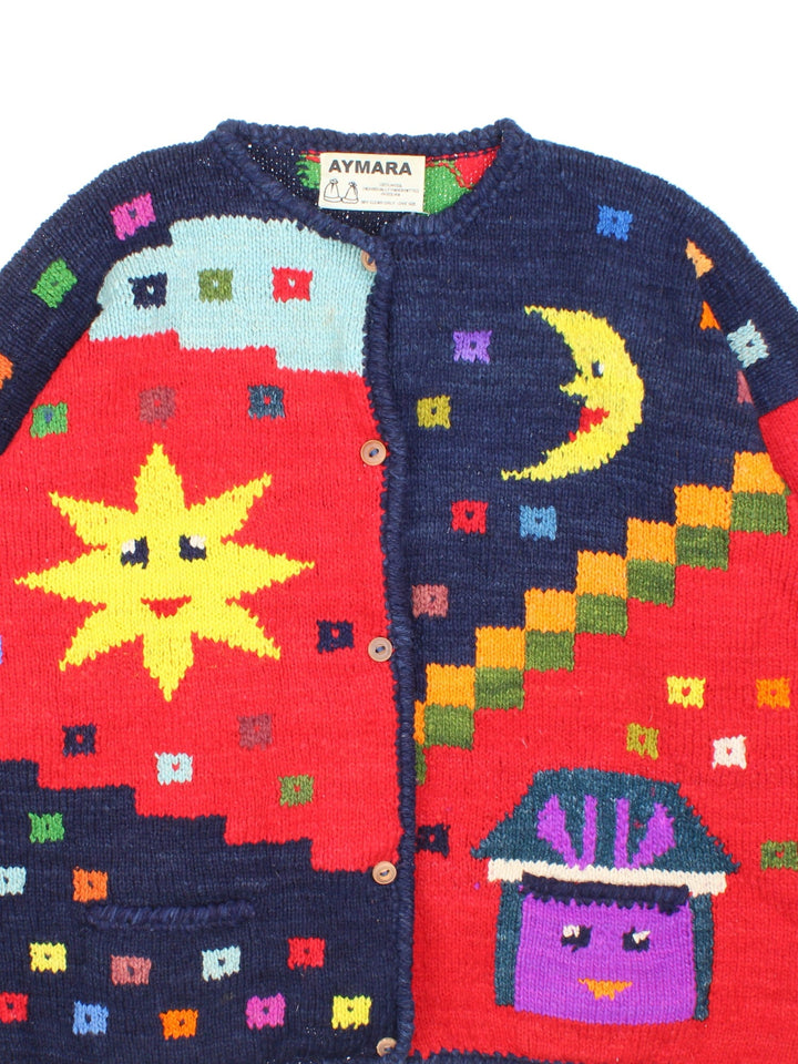 Vintage 1990s Aymara knitted cardigan in a red, and navy colourway. The cardigan has wooden buttons, and has a bright knitted pattern similar to Pachamama or Amano. It also has two small front pockets, and was made in Bolivia. 