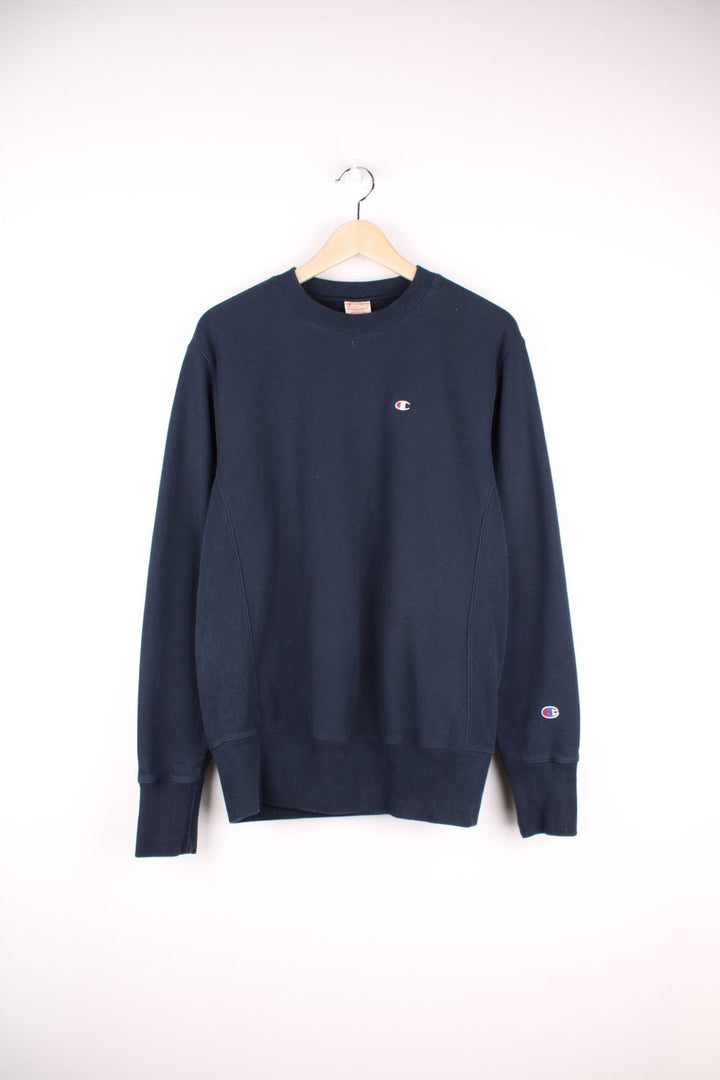 Champion reverse weave 'Warm Up' sweatshirt in navy blue with C logos embroidered on the chest and left cuff. 100% cotton. 