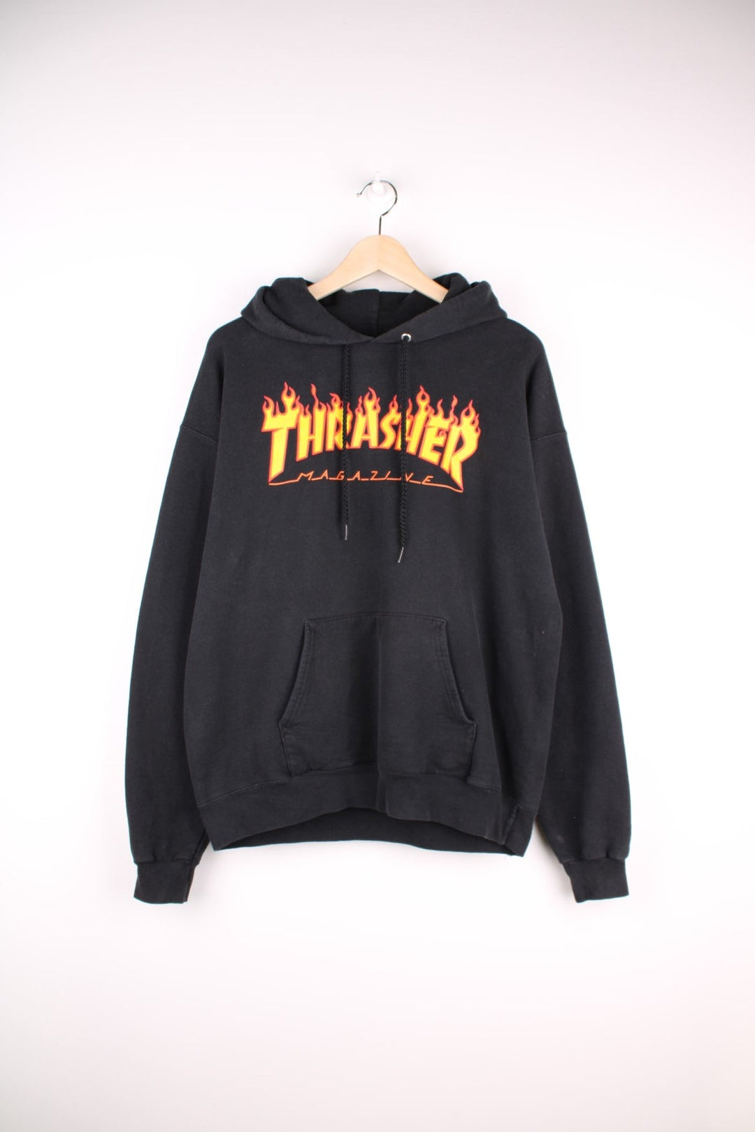 Thrasher Magazine hoodie in black with flaming spellout logo and pouch pocket. 