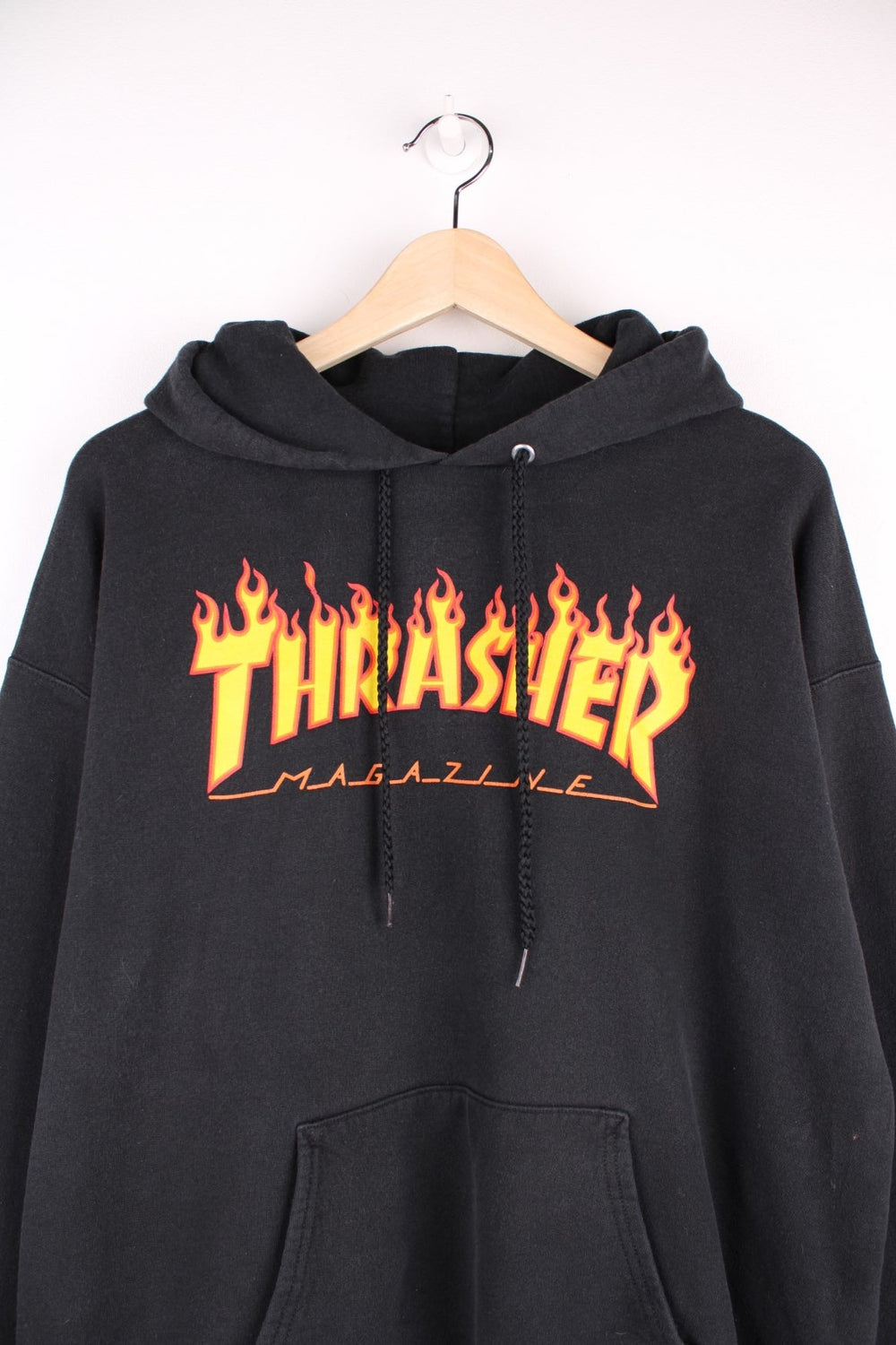 Thrasher Magazine hoodie in black with flaming spellout logo and pouch pocket. 