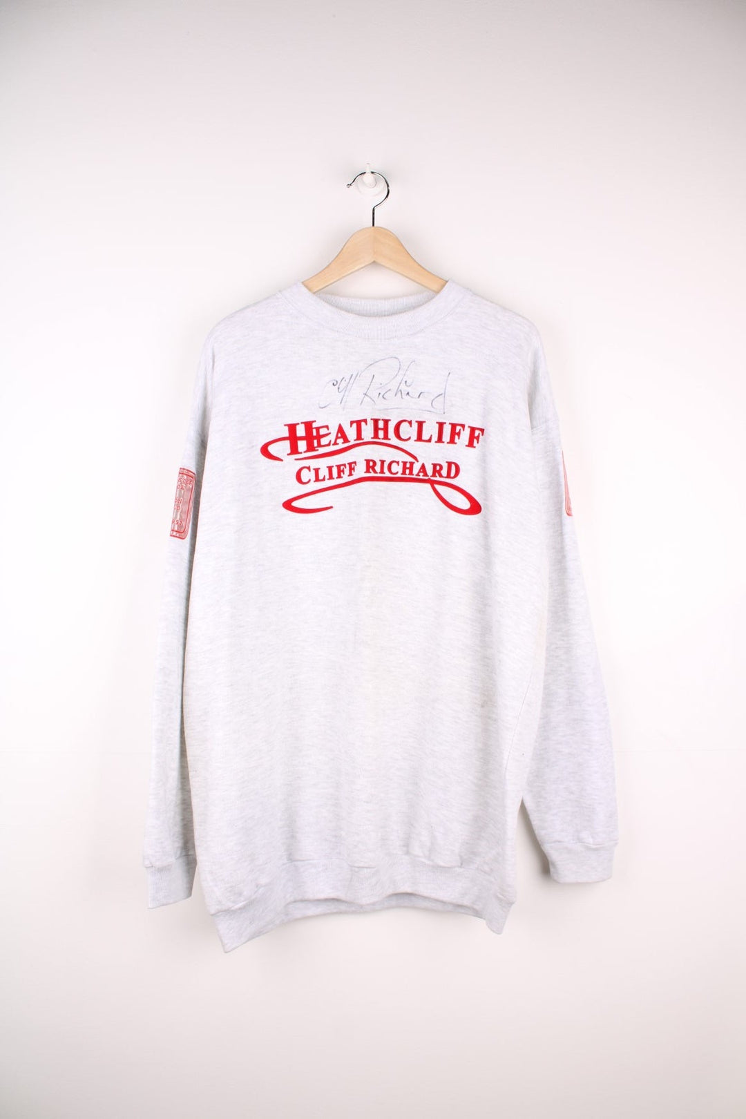 1996/97 signed Cliff Richard Heathcliff musical UK tour sweatshirt in grey marl with red embroidered text and shiny patches on the sleeves listing the tour cities and dates. 