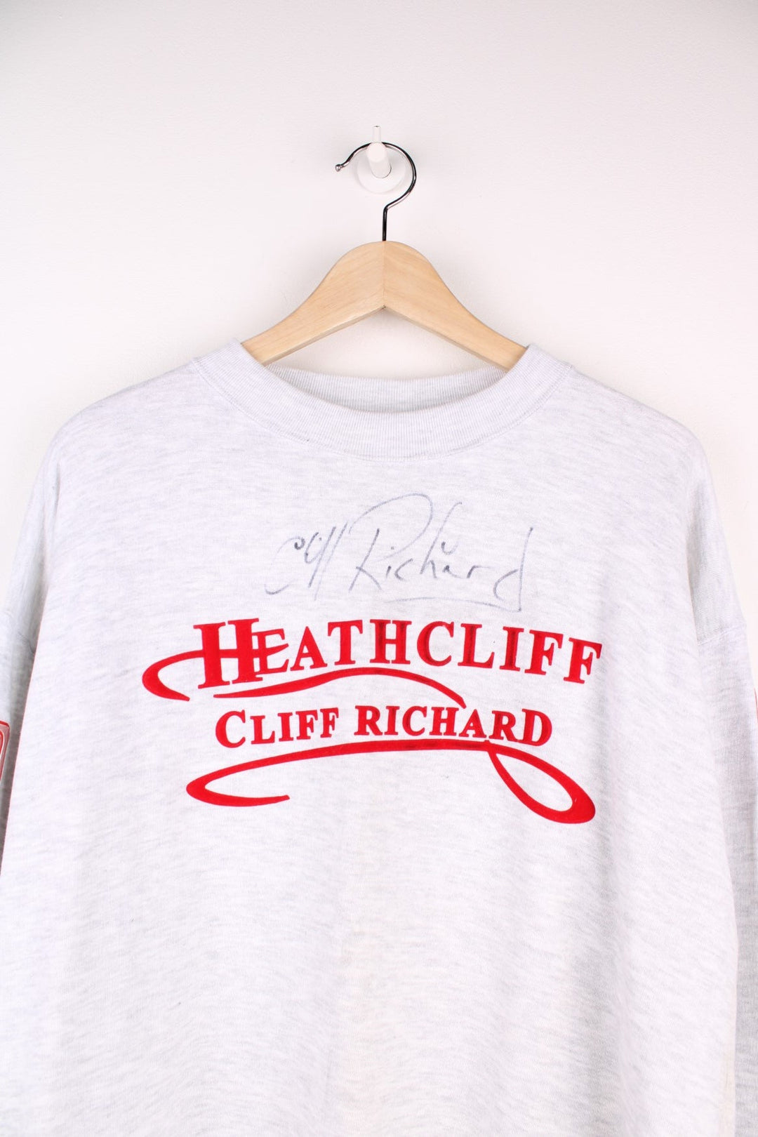 1996/97 signed Cliff Richard Heathcliff musical UK tour sweatshirt in grey marl with red embroidered text and shiny patches on the sleeves listing the tour cities and dates. 