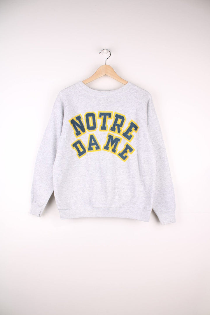 Notre Dame sweatshirt in grey marl with printed embroidered-effect spellout in green and yellow. 