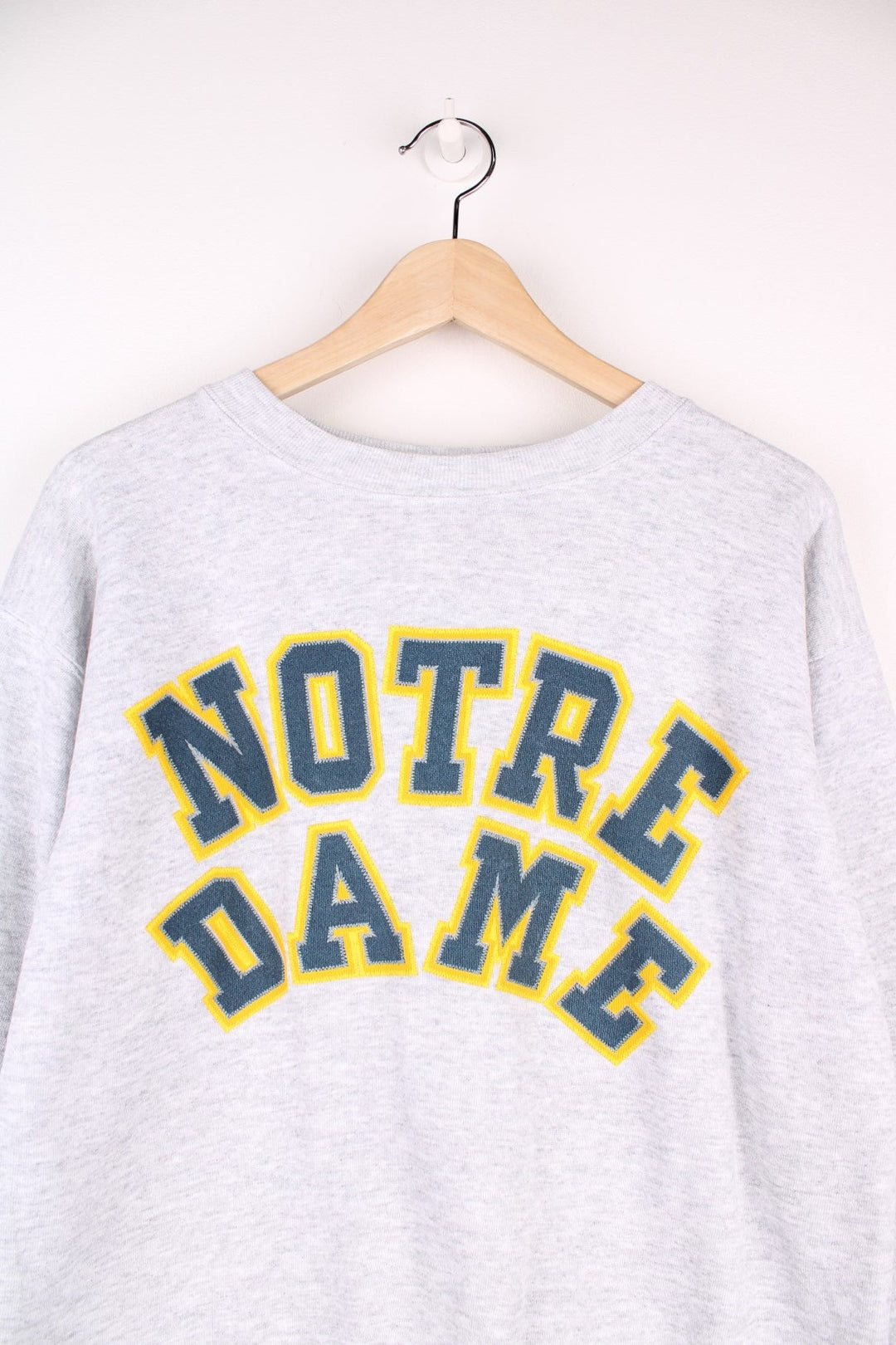 Notre Dame sweatshirt in grey marl with printed embroidered-effect spellout in green and yellow. 