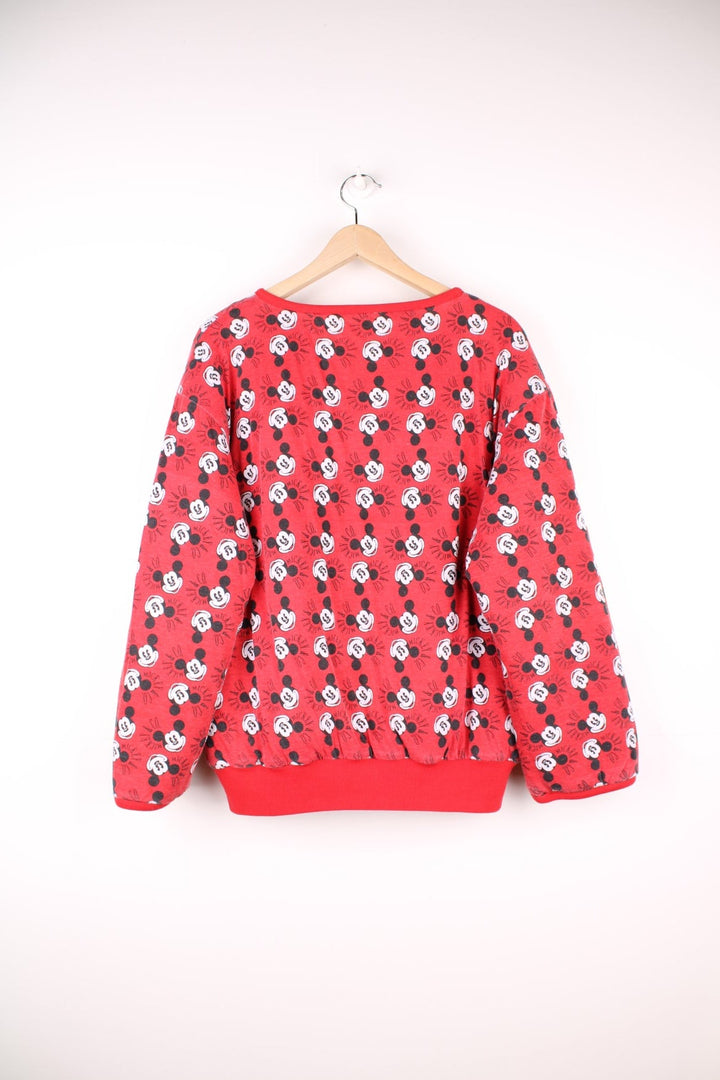 80s/90s Disney reversible lined sweatshirt with one red, yellow, and blue colourblocking side featuring a large Mickey Mouse graphic and text reading 'Mickey and Co.', and one red side with a repeating Mickey head pattern. 