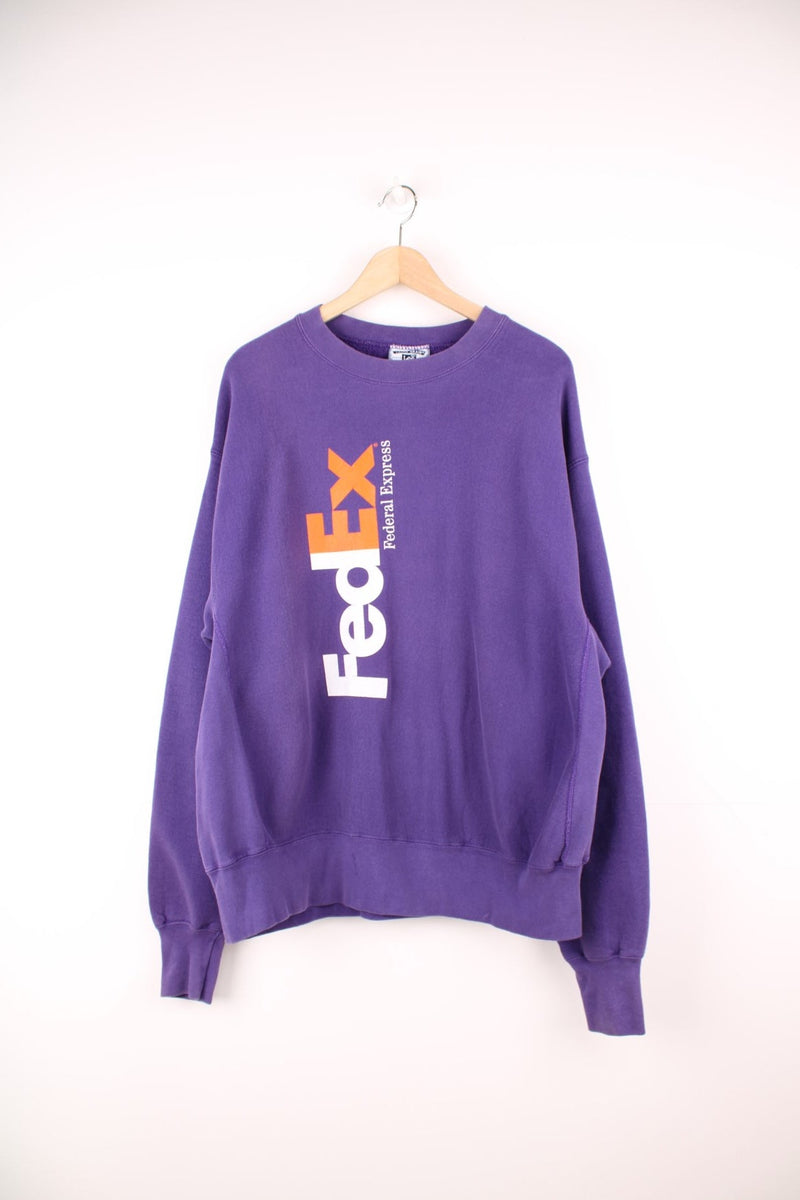 Vintage 90s FedEx purple sweatshirt by Lee. Features printed spell out logo in white and orange.