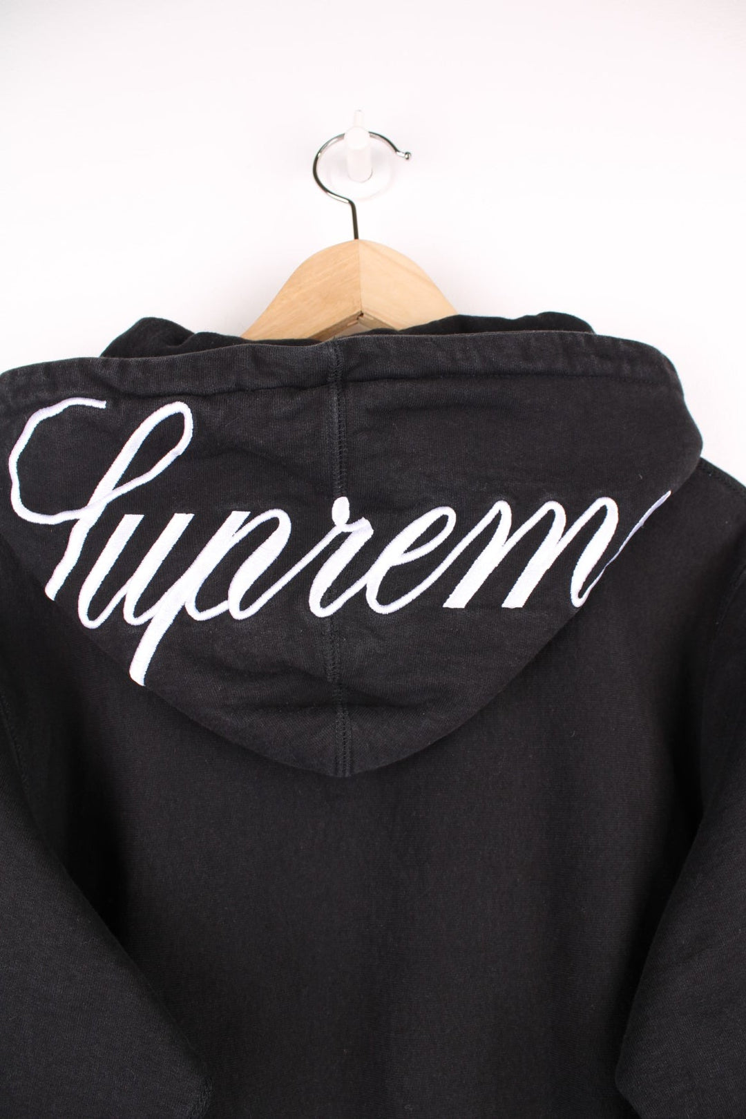 Supreme black classic script hoodie. Features pouch pocket and embroidered spell out logo on the hood.