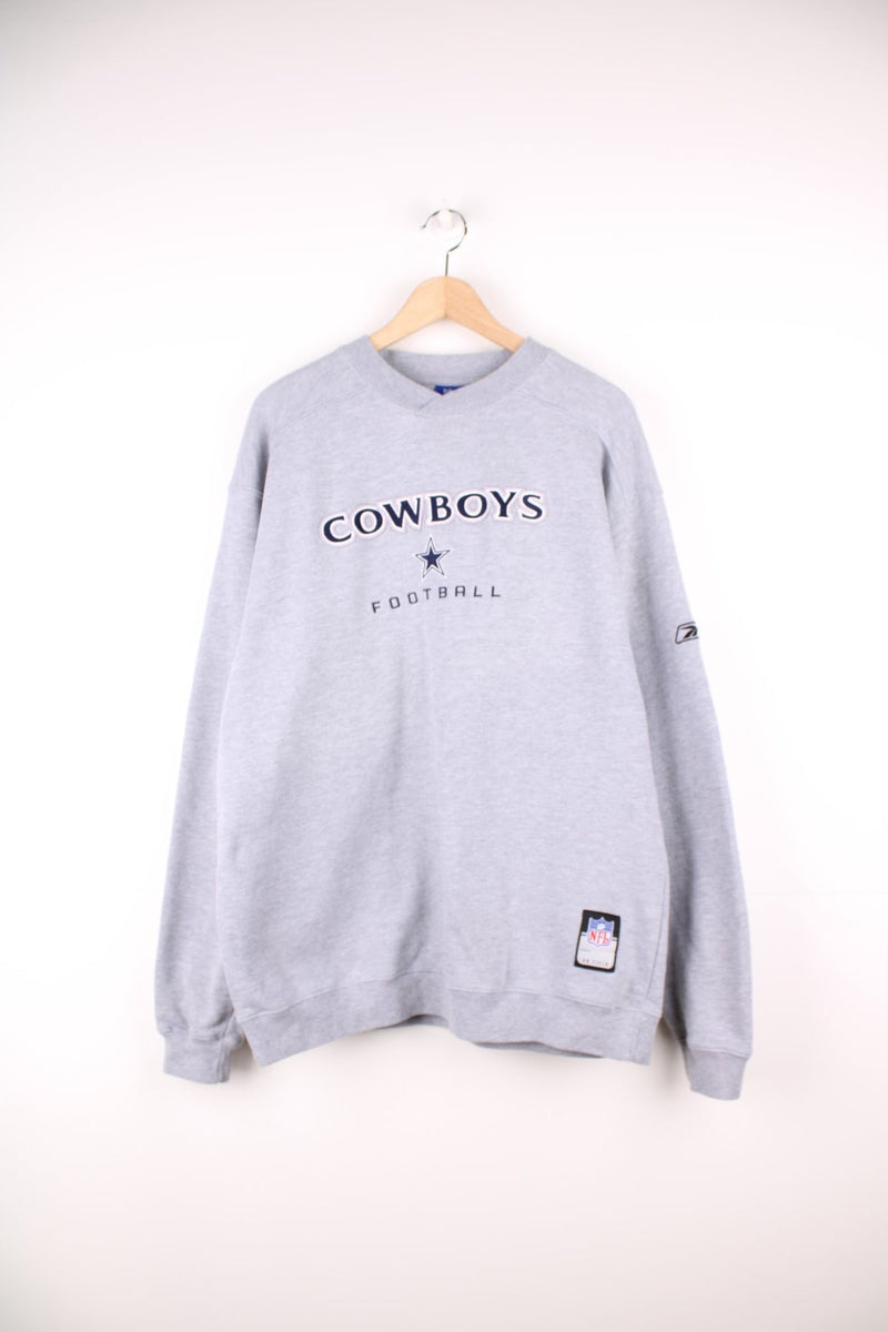 NFL Dallas Cowboys Football sweatshirt in grey with embroidered spell out logo across the chest.