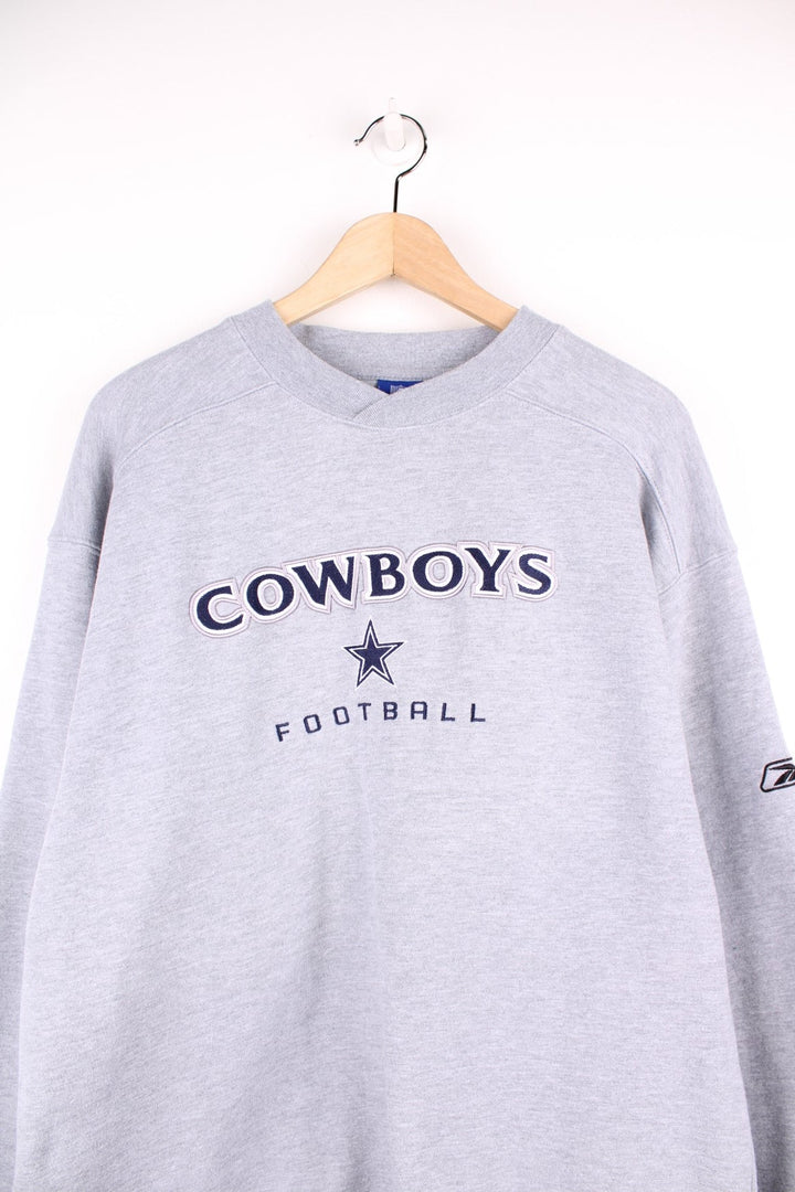 NFL Dallas Cowboys Football sweatshirt in grey with embroidered spell out logo across the chest.