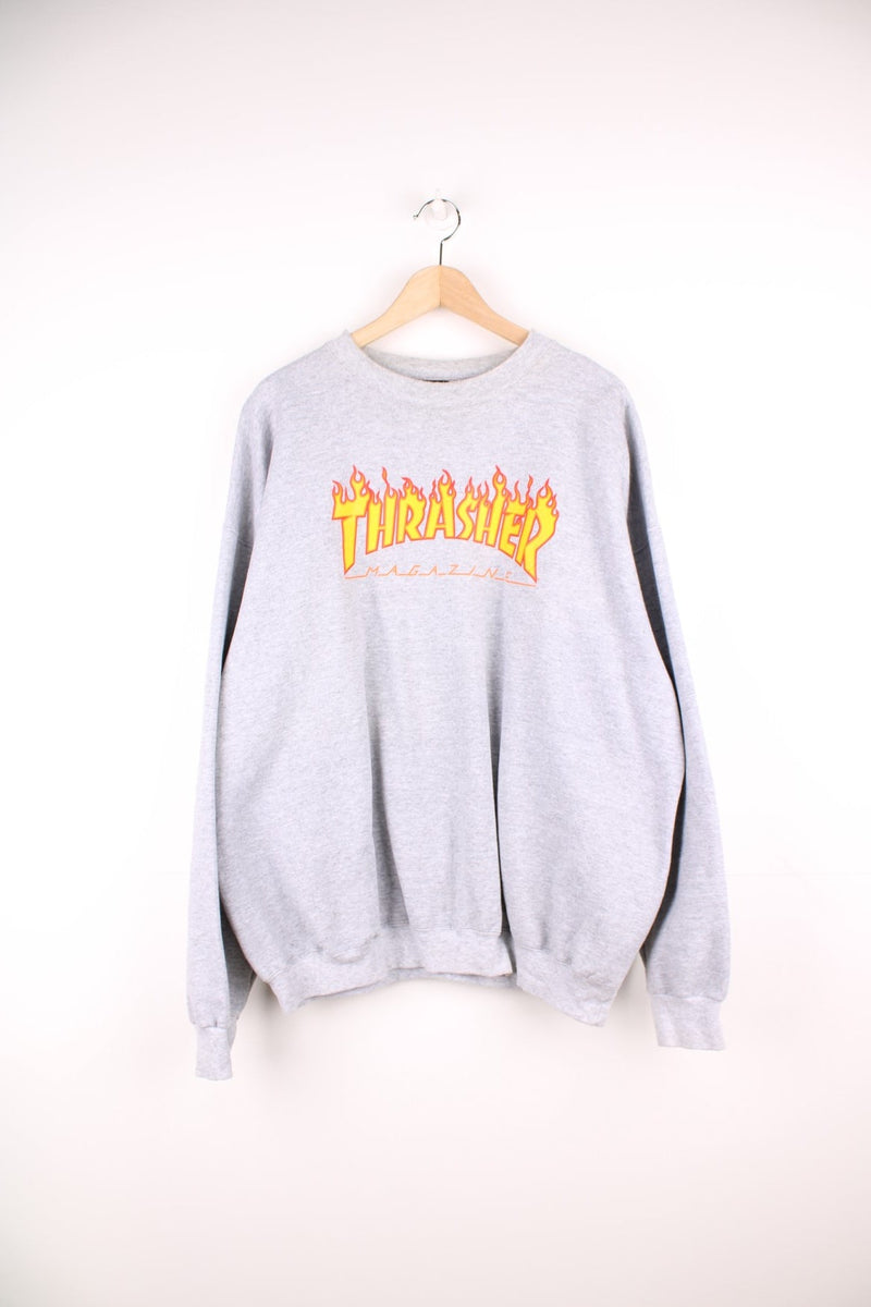 Grey Thrasher crew neck sweatshirt with printed logo across the chest. 