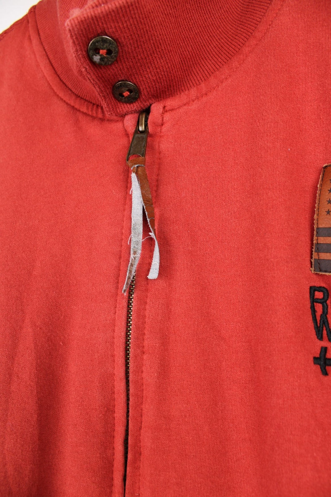  Y2K Rocawear Zip-through Sweatshirt in a red colourway with embroidered logo, button-close pockets and multiple patches stitched to the front and right sleeve.