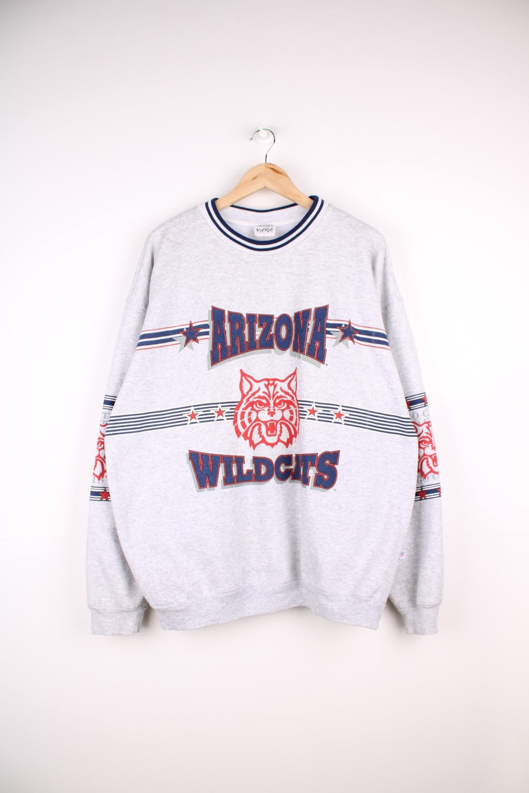  Vintage University of Arizona Wildcats Sweatshirt in grey marl with a printed logo across the chest and wrapping around sleeves.