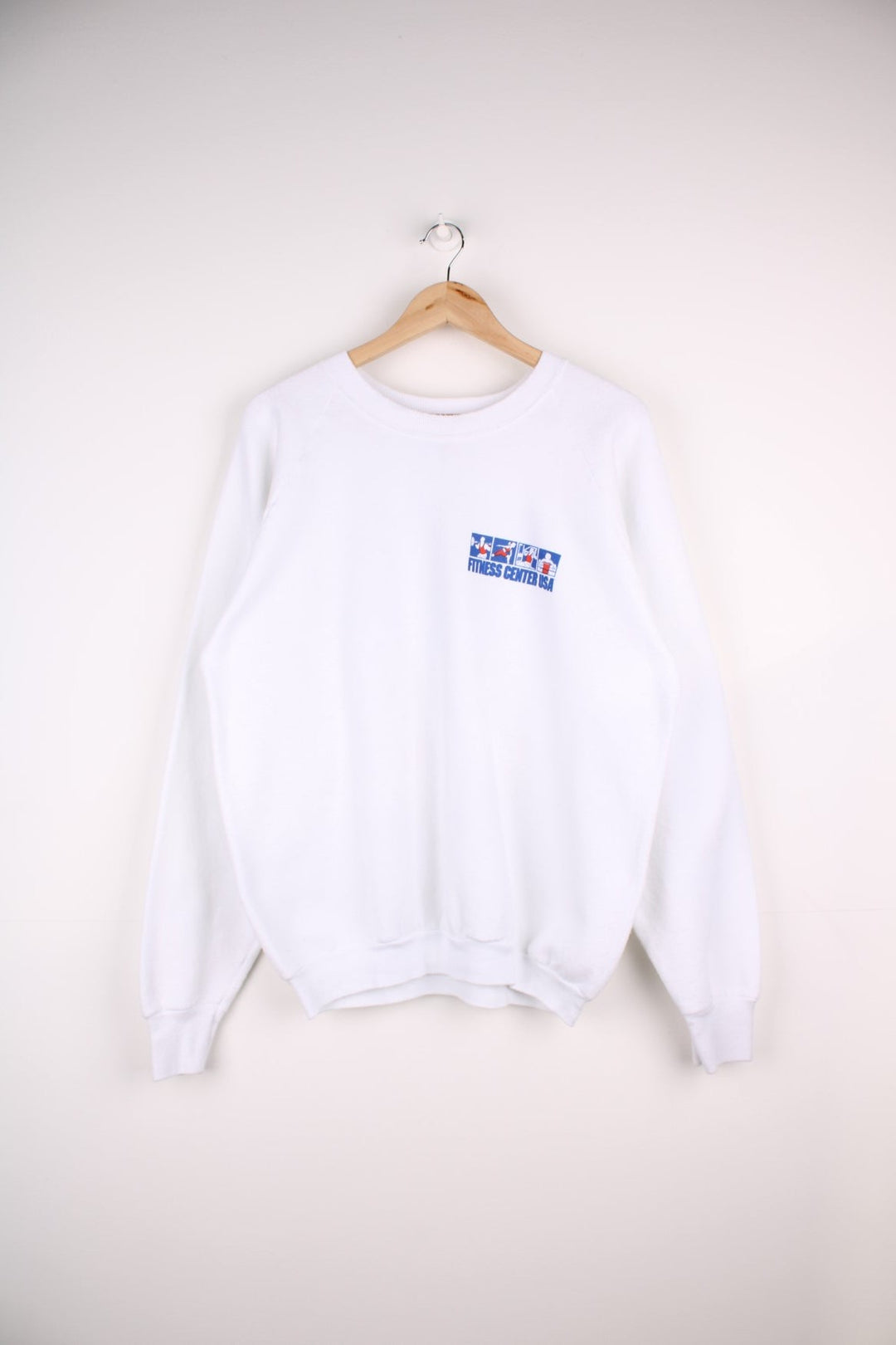  Fruit of the Loom 'Fitness Centre USA' Sweatshirt in white with a printed logo and red and blue sporty graphics on the front and across the back.