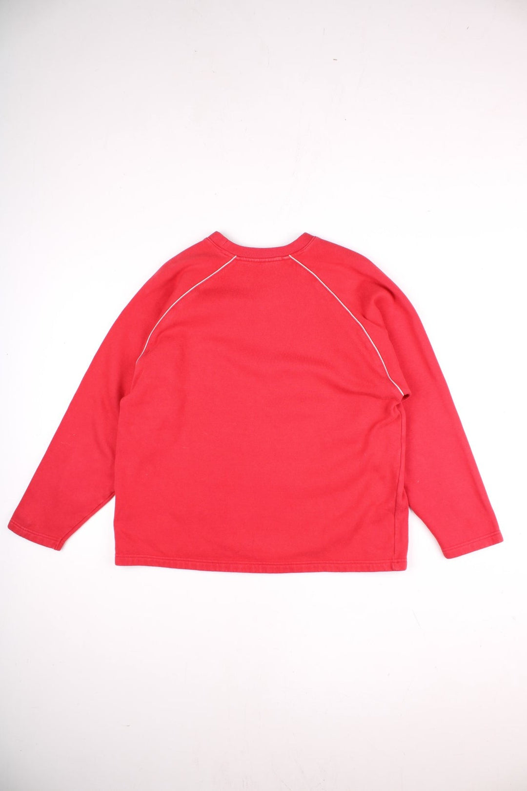 Vintage Reebok Sweatshirt in a red colourway with a large Reebok logo embroidered on the front, and white piping detail around the shoulder seams. 