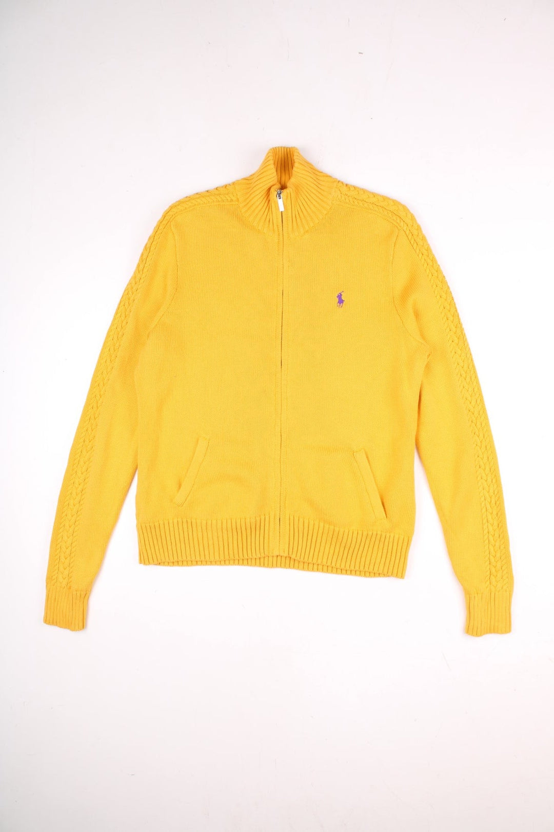 Ralph Lauren Sport zip cardigan in a mustard yellow colourway with the Ralph Lauren logo embroidered on the front chest panel. The knit has a cable knit pattern down the sleeves, ands two front pockets.